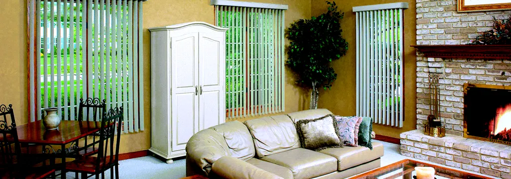 Vertical blinds beside a fireplace